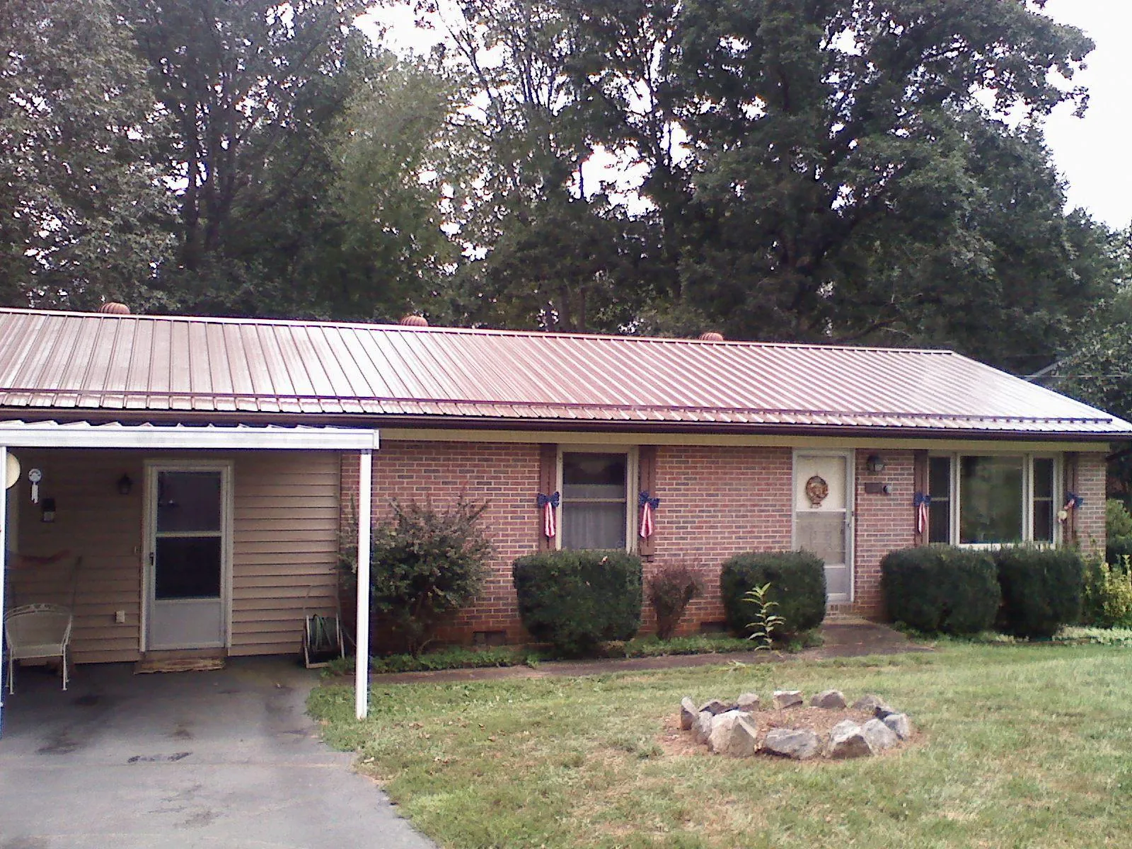 Bronze metal roof and carport on a brick ranch home — Roof Repair work by our crew in Scenery Hill
