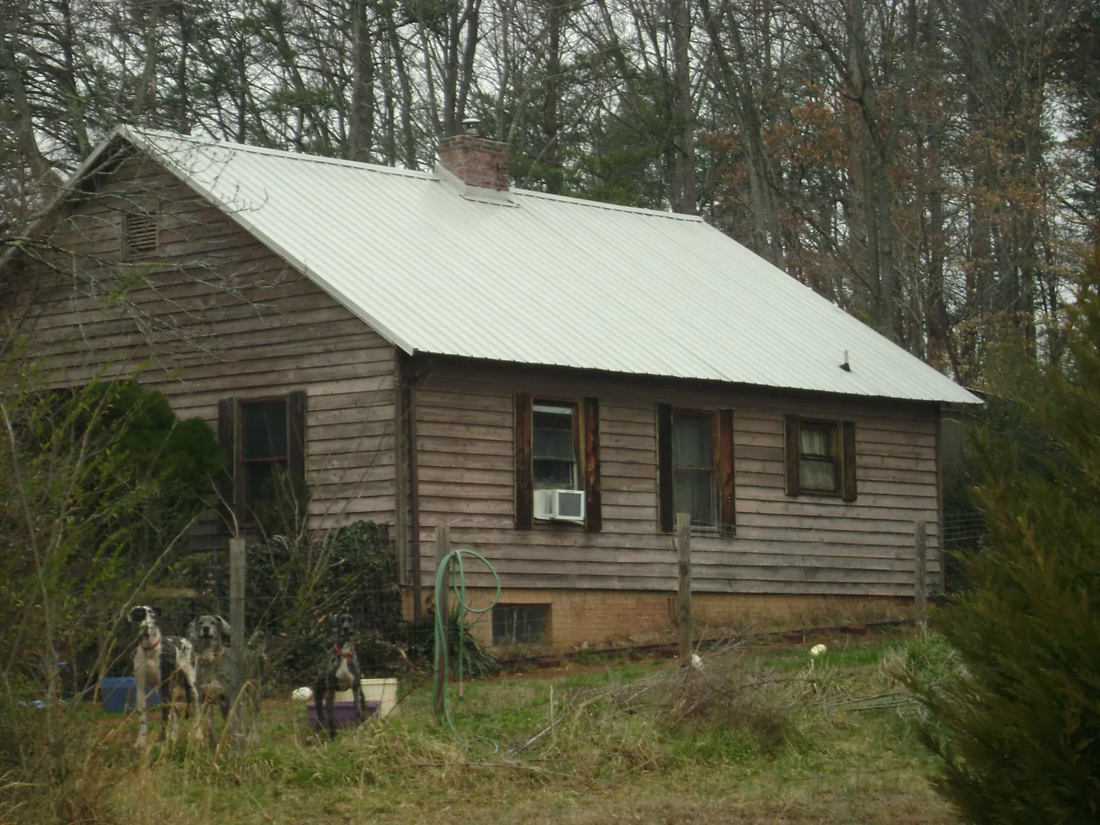 White metal roof on an old wood sided farmhouse, from a Metal Roof Installation job in Scenery Hill