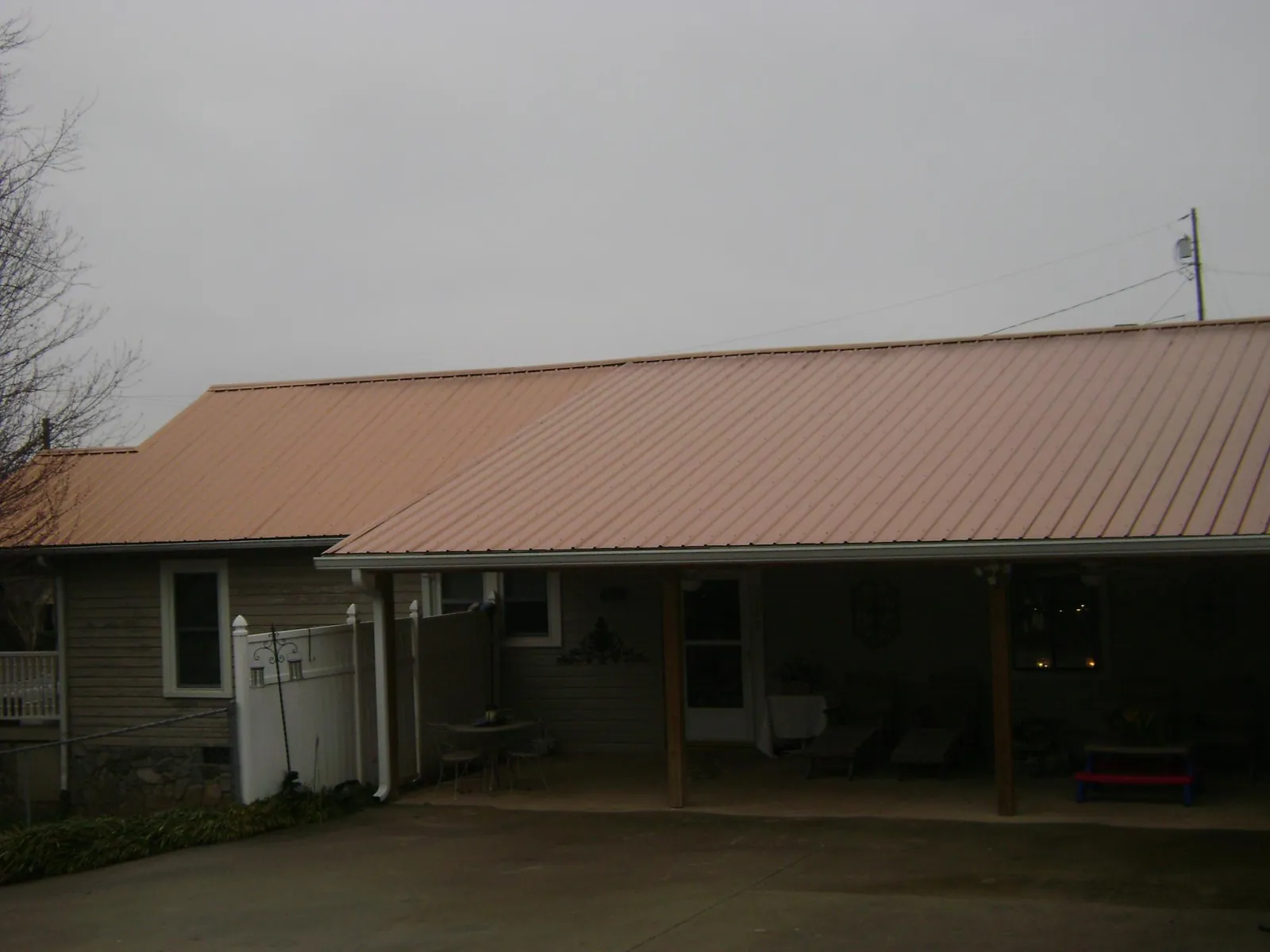 Copper toned metal roof over a wide covered patio in Scenery Hill